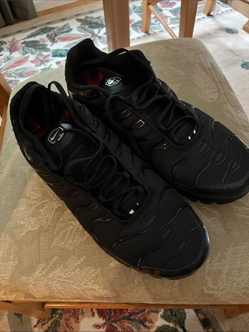 Nike Air Max Plus (Men’s) Triple Black Sneakers with Subtle Red Interior Accents